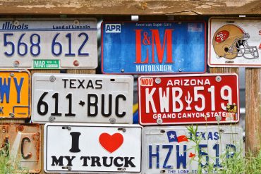Various license plates on a wall