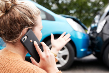 Woman on her cellphone after accident