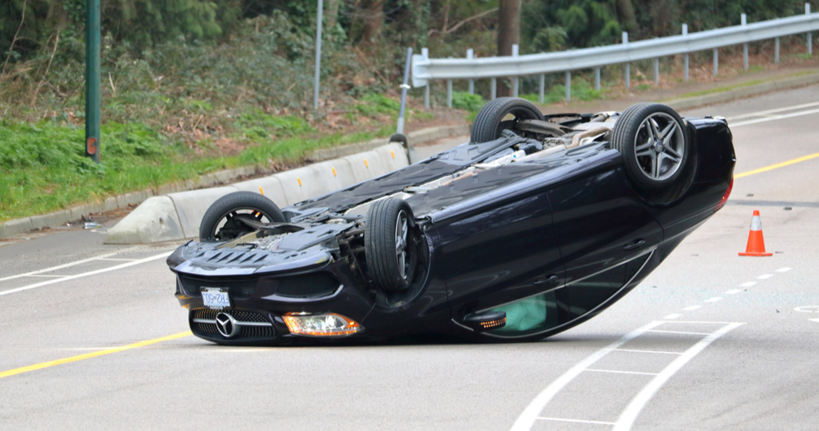Black Mercedes flipped on its back