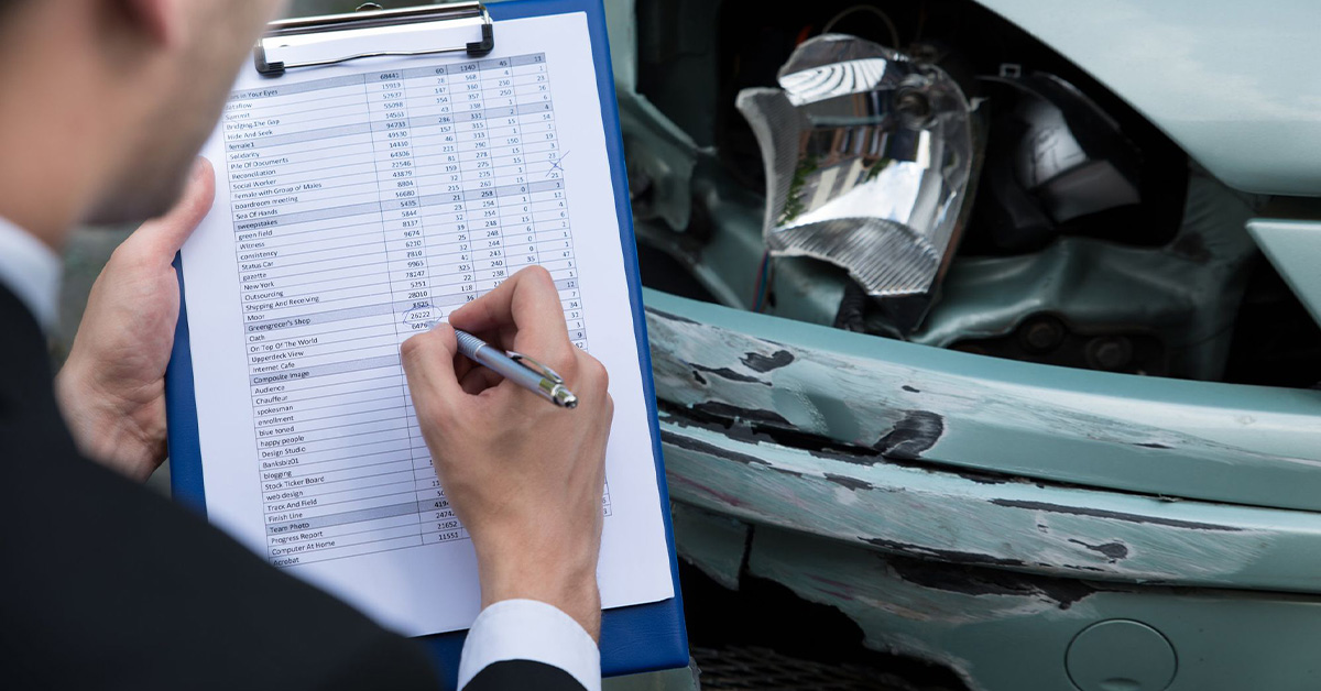 Insurance company adjuster in car crash scene